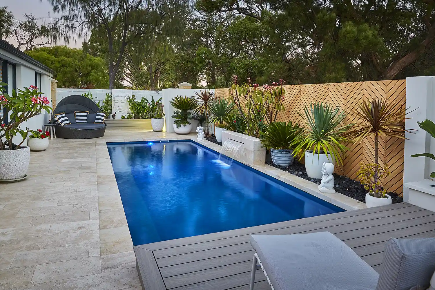 Heron Series Compact Fibreglass Pool Heron Series compact fibreglass pool with feature water blade and landscaping