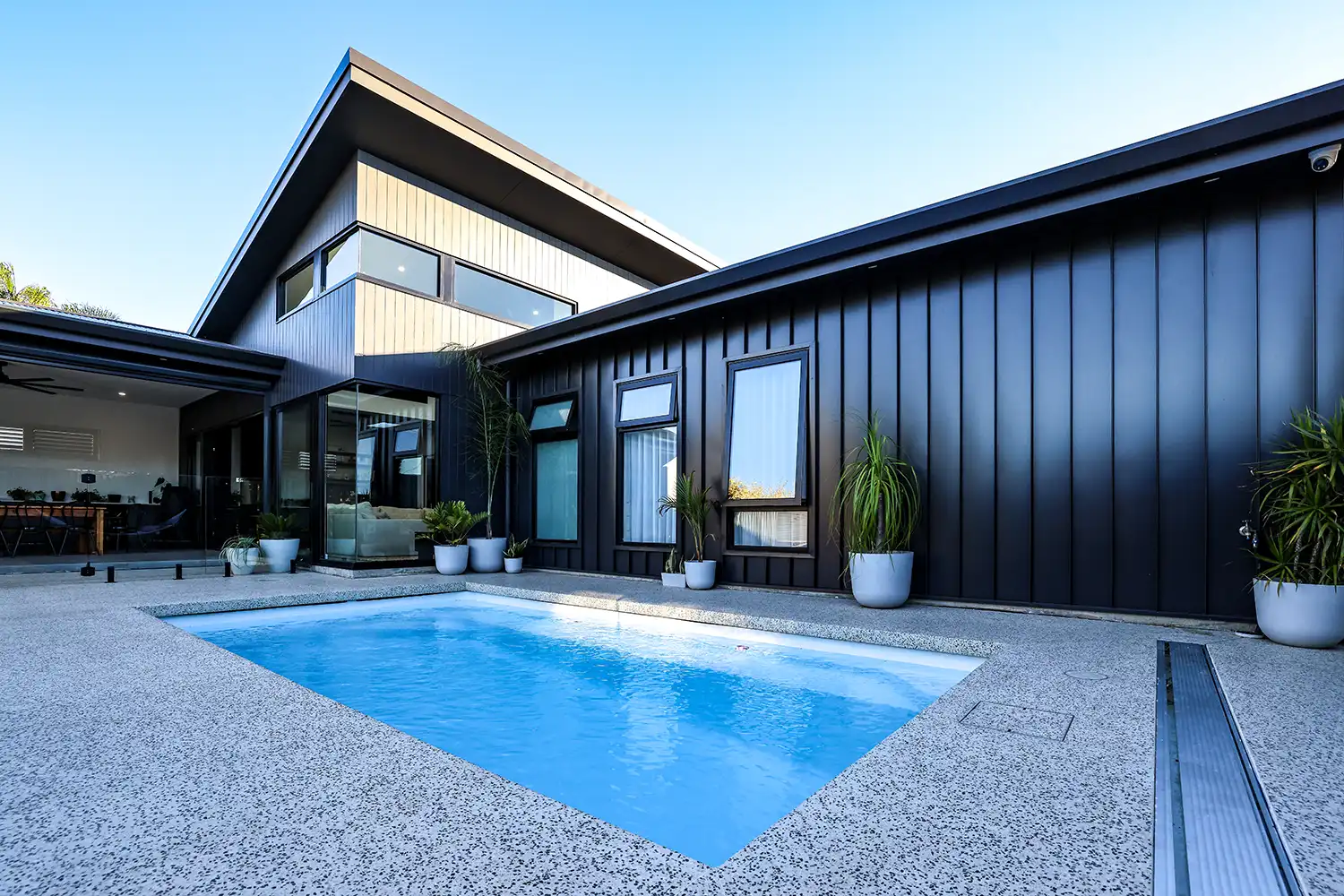Heron Series Compact Fibreglass Pool Heron Series compact fibreglass pool beside a contemporary Queensland home