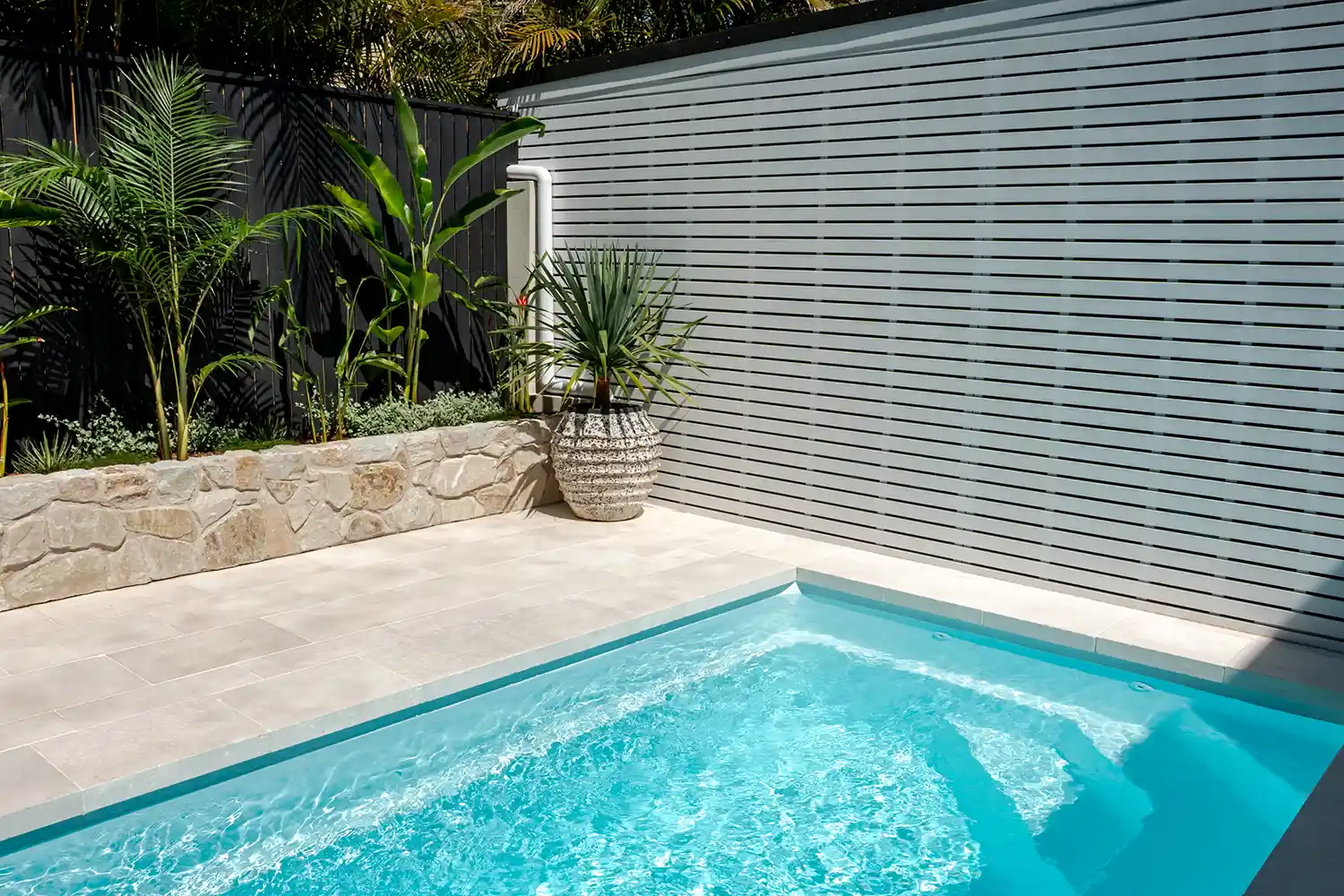 Heron Series Compact Fibreglass Pool Seating Area Heron Series compact fibreglass pool with integrated bench seating