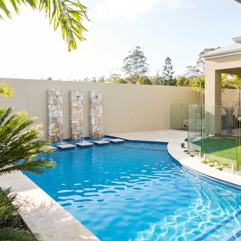 Build a concrete pool with custom water feature on the Sunshine Coast