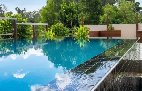 Custom concrete infinity edge pool with black tiled waterline on the Sunshine Coast