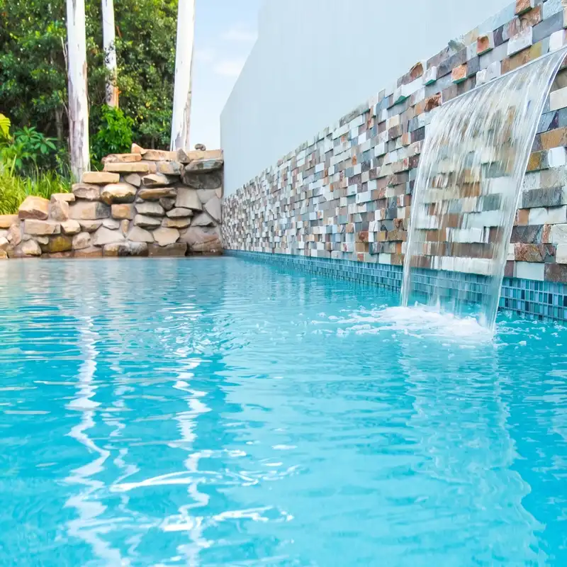 Concrete pool finish creating vibrant aqua water colour in a custom swimming pool