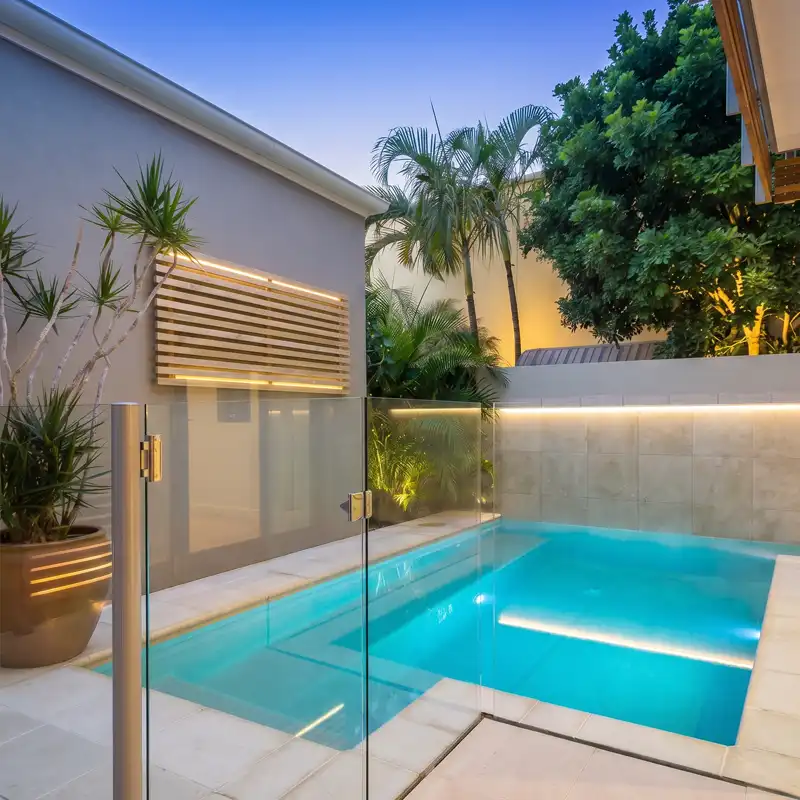 Custom plunge pool with glass fencing and feature lighting on the Sunshine Coast