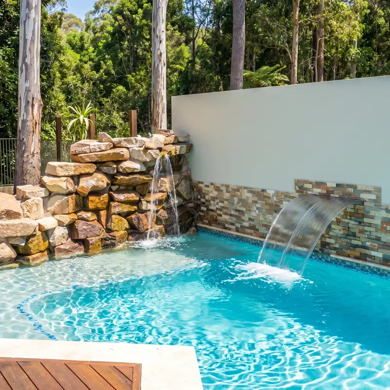 Custom concrete pool with waterfall and water blade feature on the Sunshine Coast