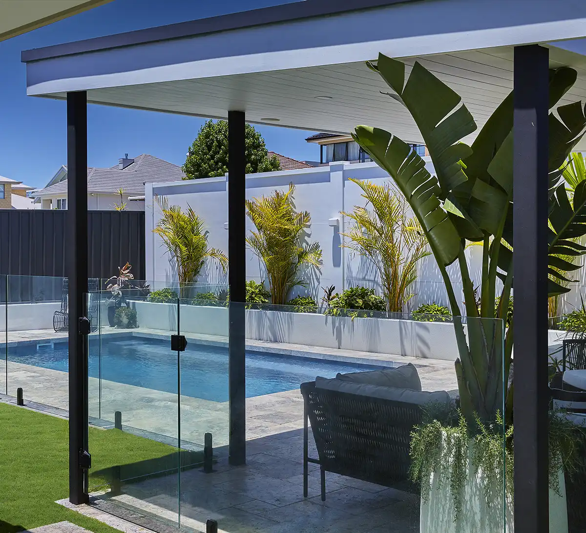 Hamilton Series rectangular fibreglass pool with glass pool fencing and contemporary outdoor entertaining area