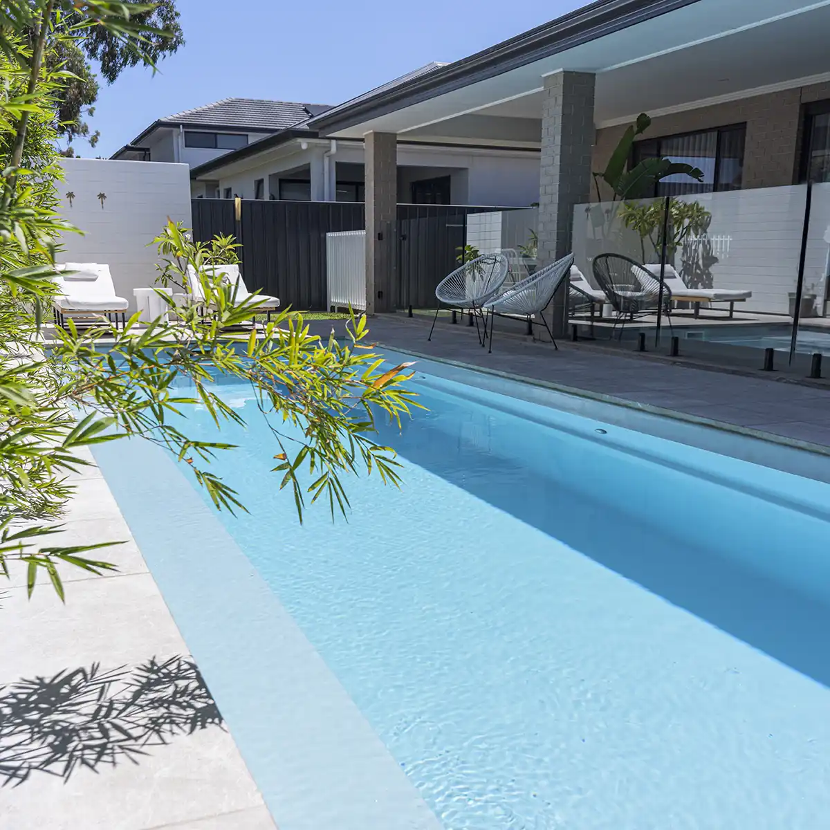 Hampton Lap Pool Series fibreglass lap pool beside a modern outdoor entertaining area