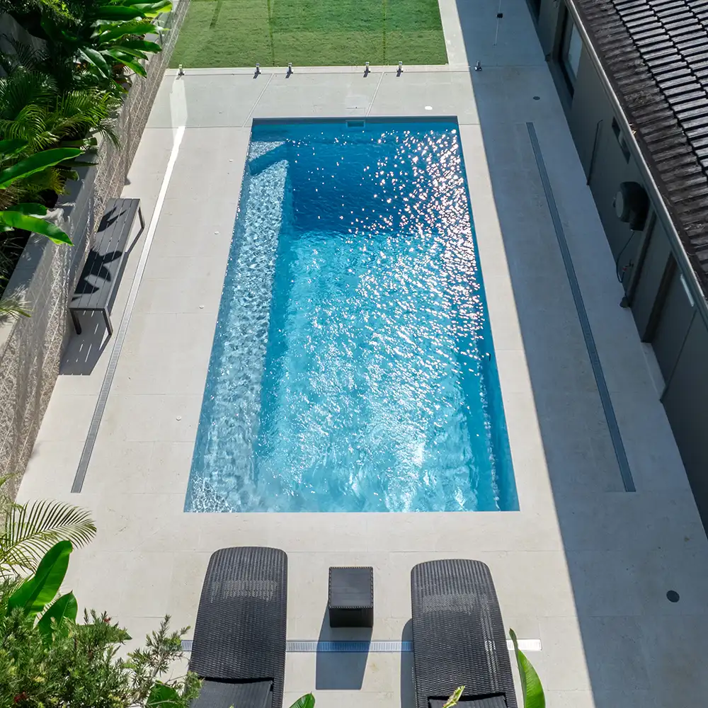 Overhead view of the Hampton Series luxury fibreglass pool featuring full-length bench seating and spacious swimming area