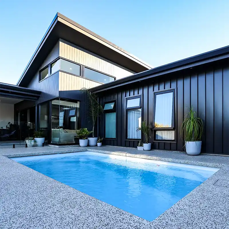 Heron Series compact fibreglass pool beside a modern Sunshine Coast home