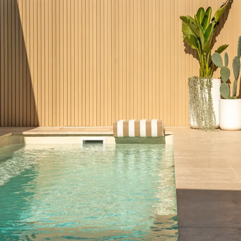 Imperial Series narrow fibreglass pool with full-length bench seating and modern outdoor design