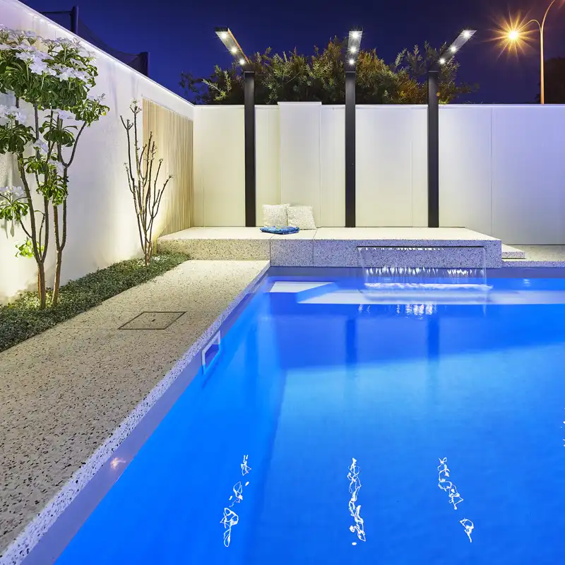 Modern swimming pool with water feature built by a Peregian pool builder for a contemporary coastal home