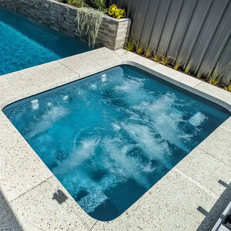 Fibreglass spa with hydrotherapy jets integrated into a modern outdoor entertaining area.