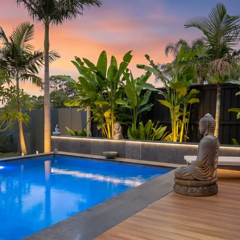 Custom pools Sunshine Coast Custom swimming pool with tropical landscaping and feature lighting on the Sunshine Coast