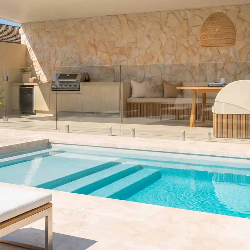 Bay Series fibreglass pool with full-width entry steps and outdoor entertaining area